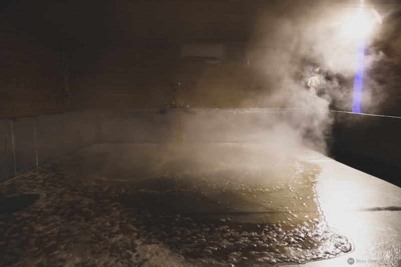 Hot wort trucked over from  the brewhouse hits the coolship for the first time