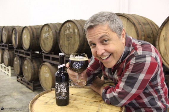 Three Taverns founder Brian Purcell shows off Bourbon Feest Noel in the brewery's barrel room.
